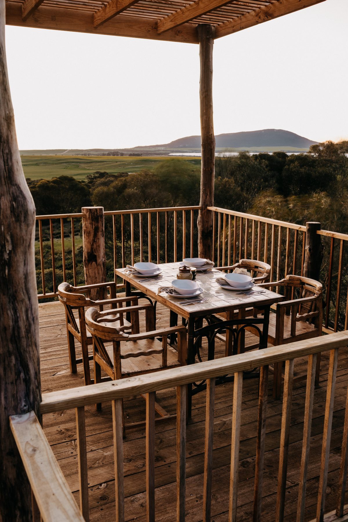 Deck dining table overlooking the coast at The Greenly Carriage